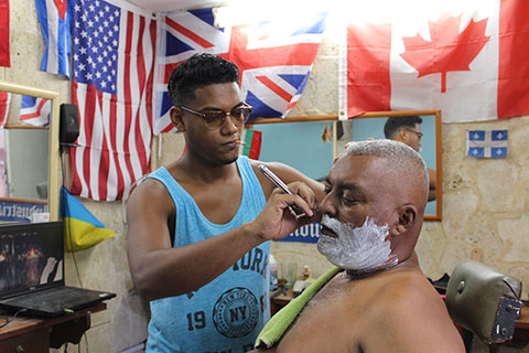 Man getting a shave at a barber shop.