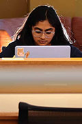 A student works on a computer in the library