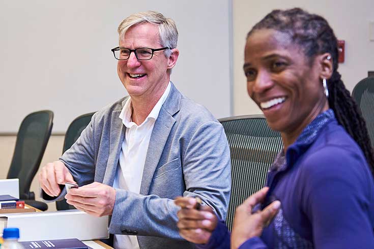 People in a classroom smiling