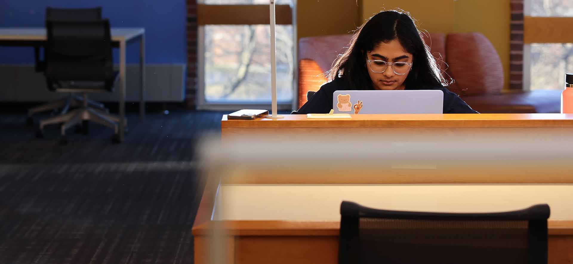 Brandeis students at a desk with computer
