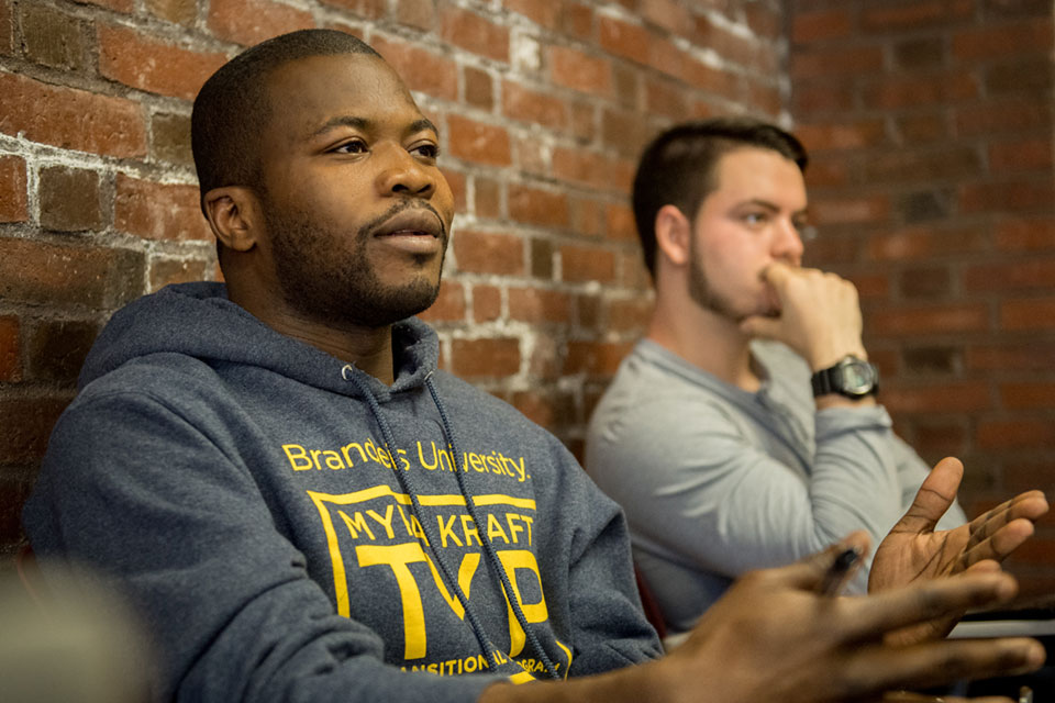 A student in a TYP sweatshirt speaks in class