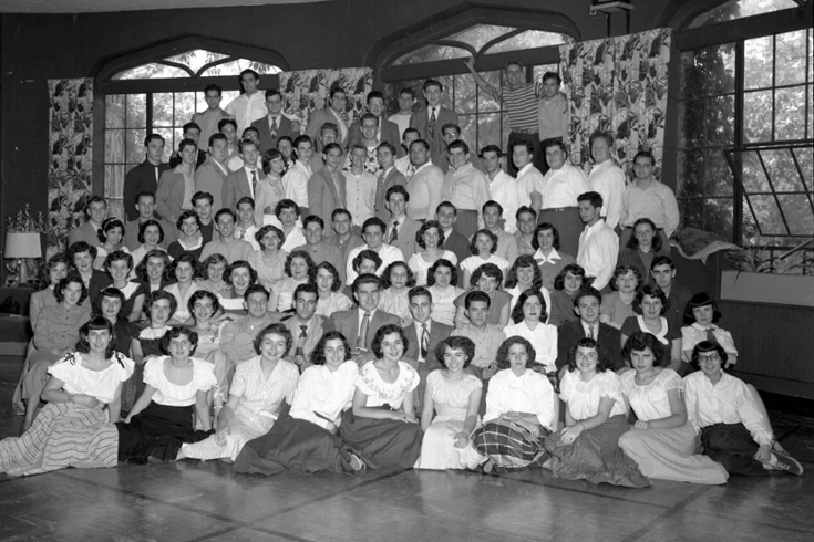 a black and white class photo of a little more than 100 students, in rows
