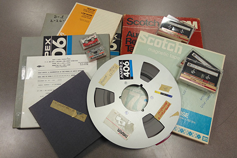 A pile of records, cassette tapes, and a film reel