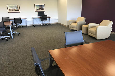 Room with table, chairs, and computer desk