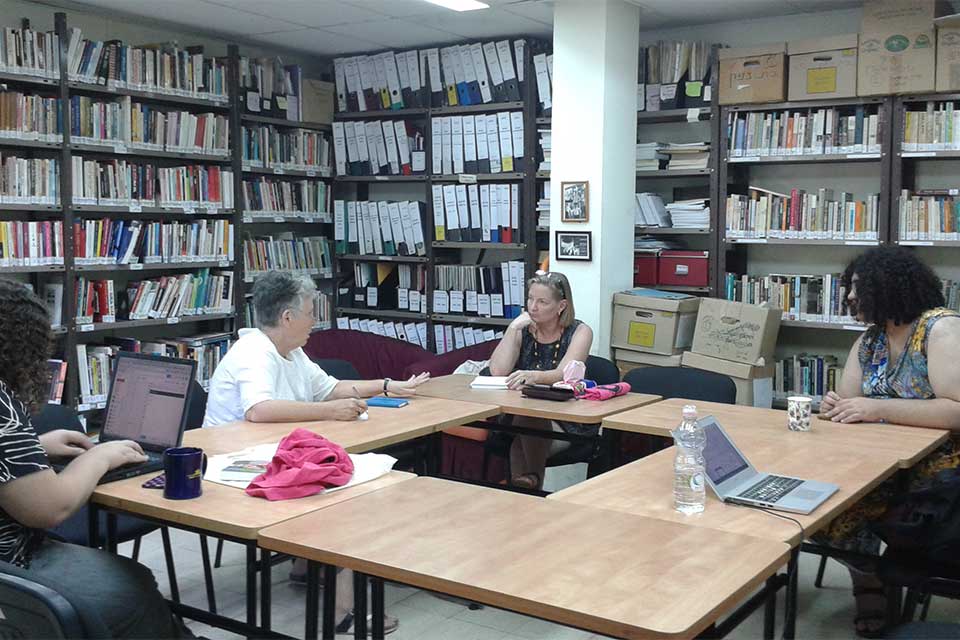 The Lesbian Archive staff at a steering meeting sitting around a table