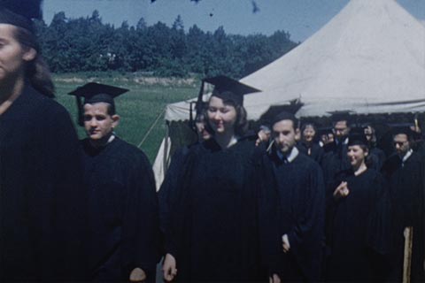 Students in caps and gowns walking in the first commencement ceremony