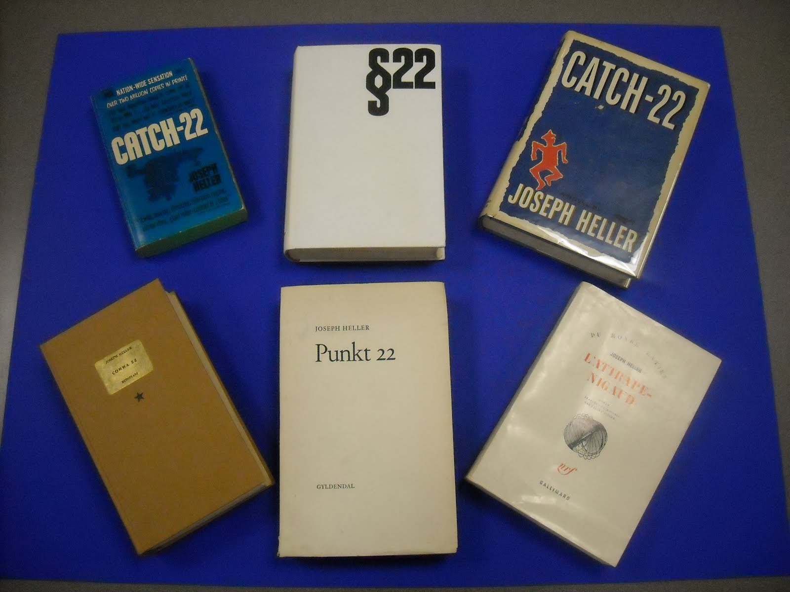 Photograph of different book cover editions for Catch-22 by Joseph Heller