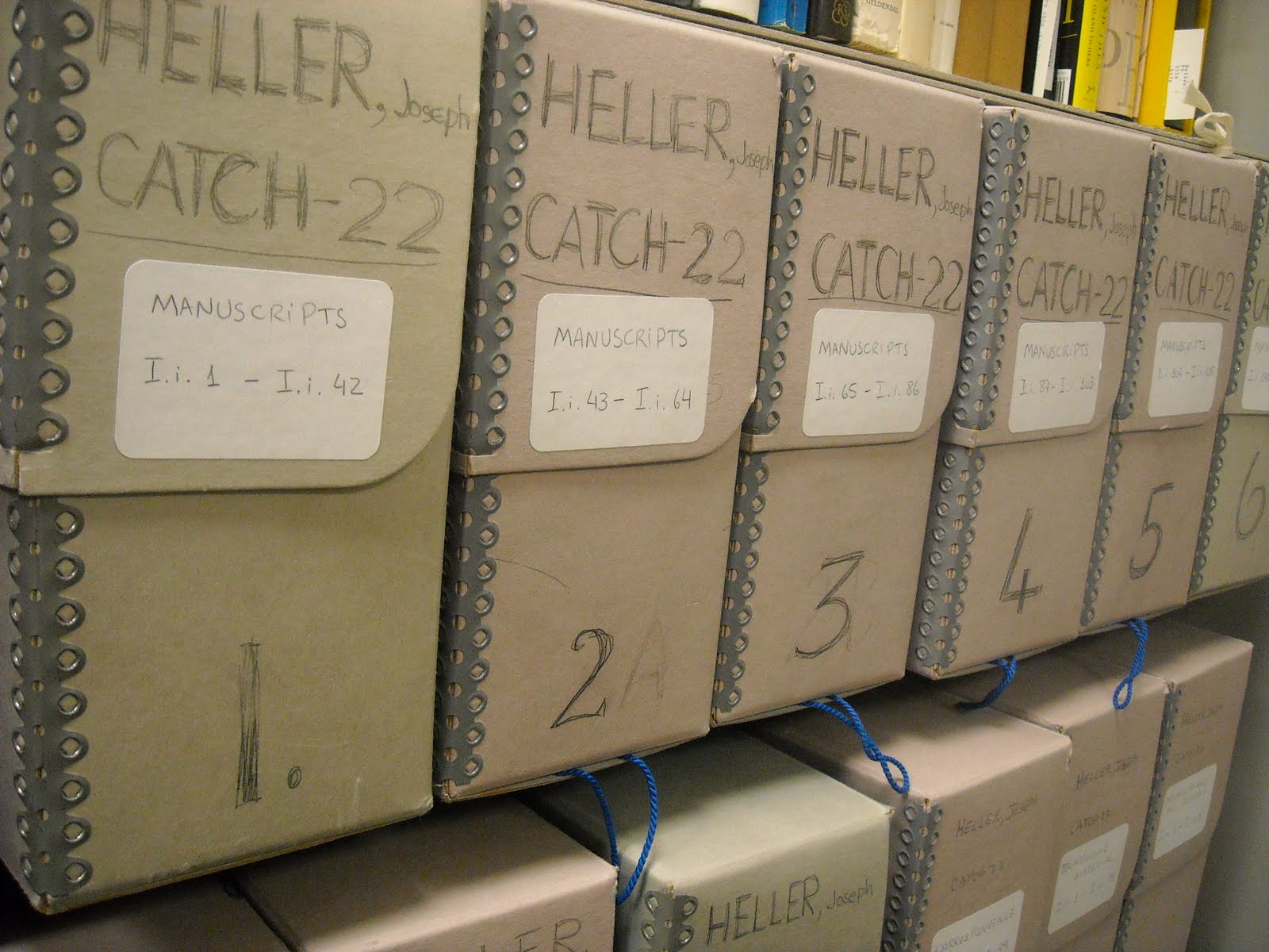 Various boxes aligned next to each other in a row, each contain a portion of the Joseph Heller Collection