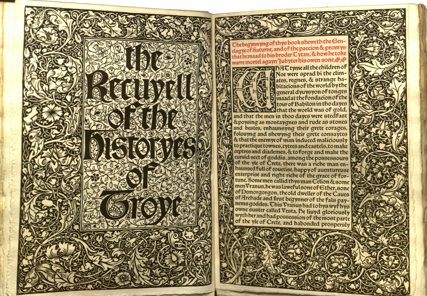 Two-page spread with title page of The Recuyell of the Historyes of Troye with ornamental decorative elements covering the page. 