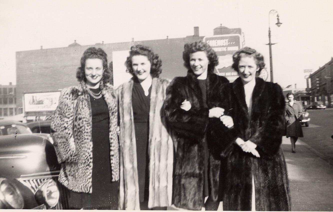 Photograph of 4 women, wearing furs