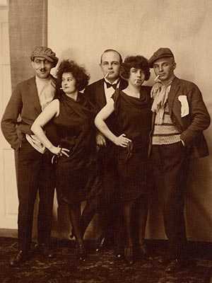 Five people posing for picture with cigarettes