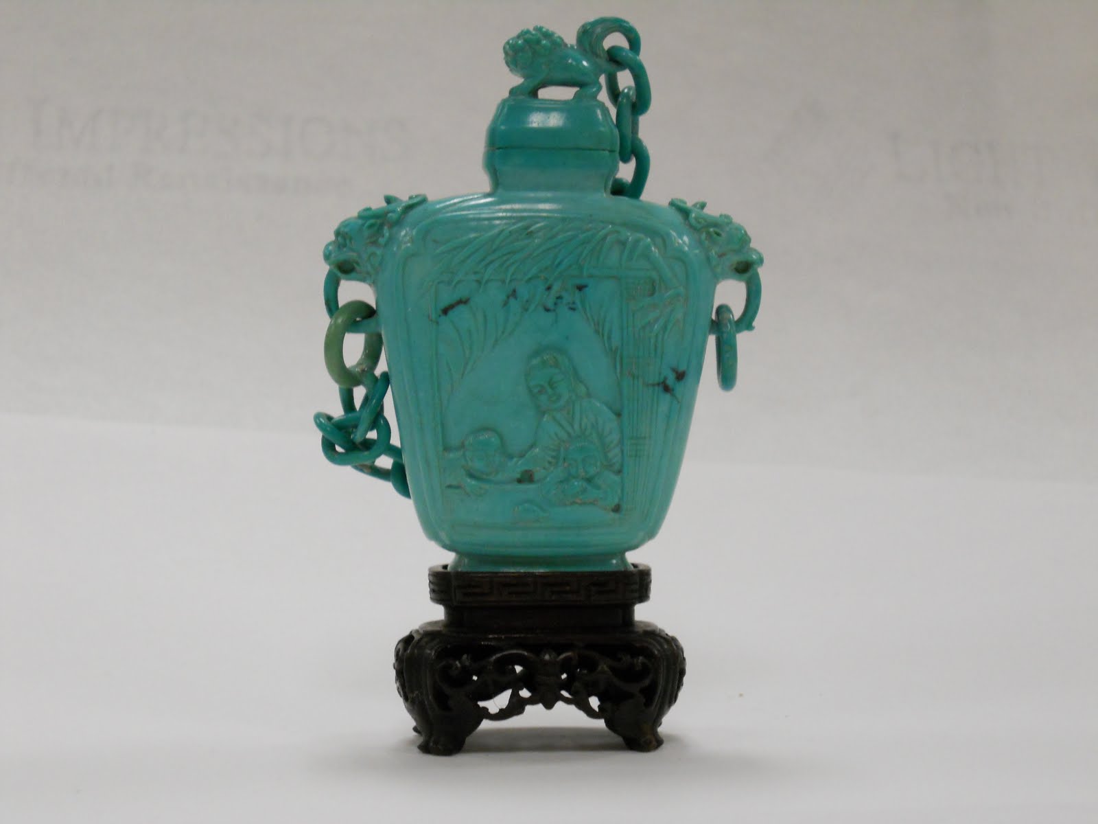 Carved turquoise snuff bottle with a chaned cover
