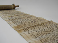 a scroll, unrolled on a table.