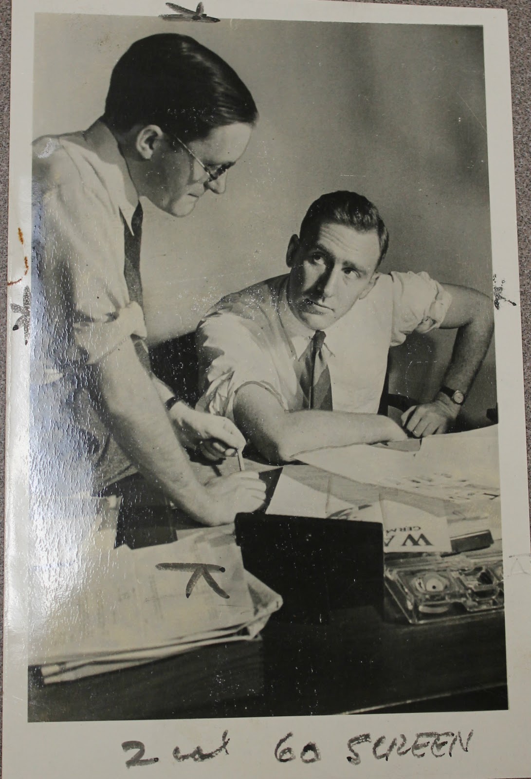 A black and white photograph of Michael Sayers on the left and Albert Kahn on the right