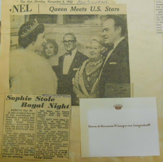 scrapbook with news clipping with headline: Sophie Stole Royal Night. Photograph shows the Queen of England talking to Sophie Tucker and 3 others.