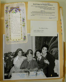 scrapbook page with greeting cards, large black and white photo posing with a woman and children, and correspondence