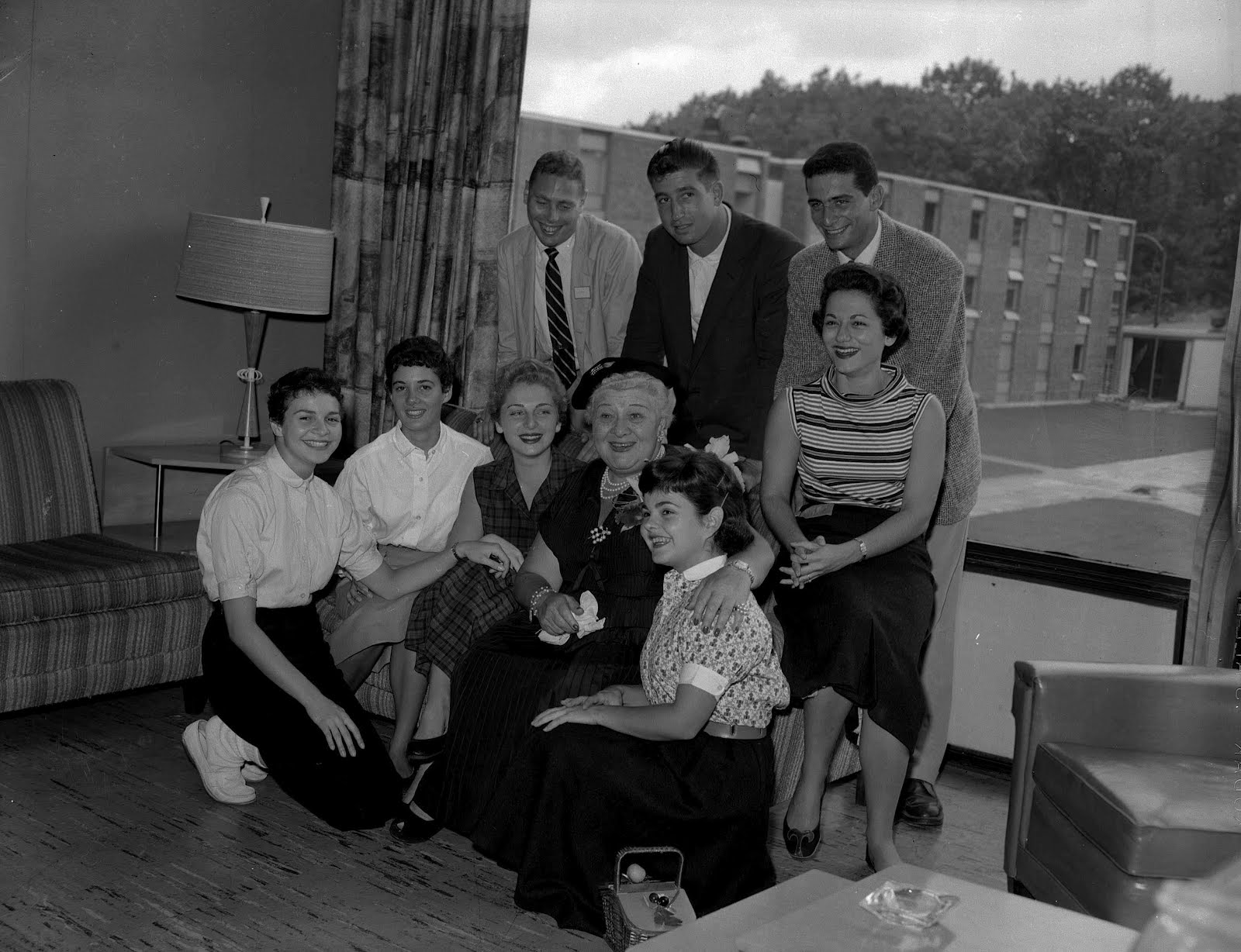 Black and white photograph of Sophie Tucker posing with students