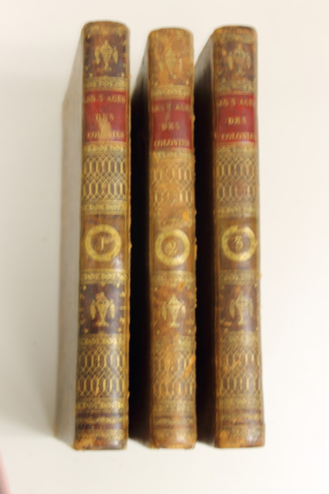 The spines of Dufour de Pradt’s three-volume 1801 work Les trois ages des colonies, ou de leur état passé, présent, et à venir
