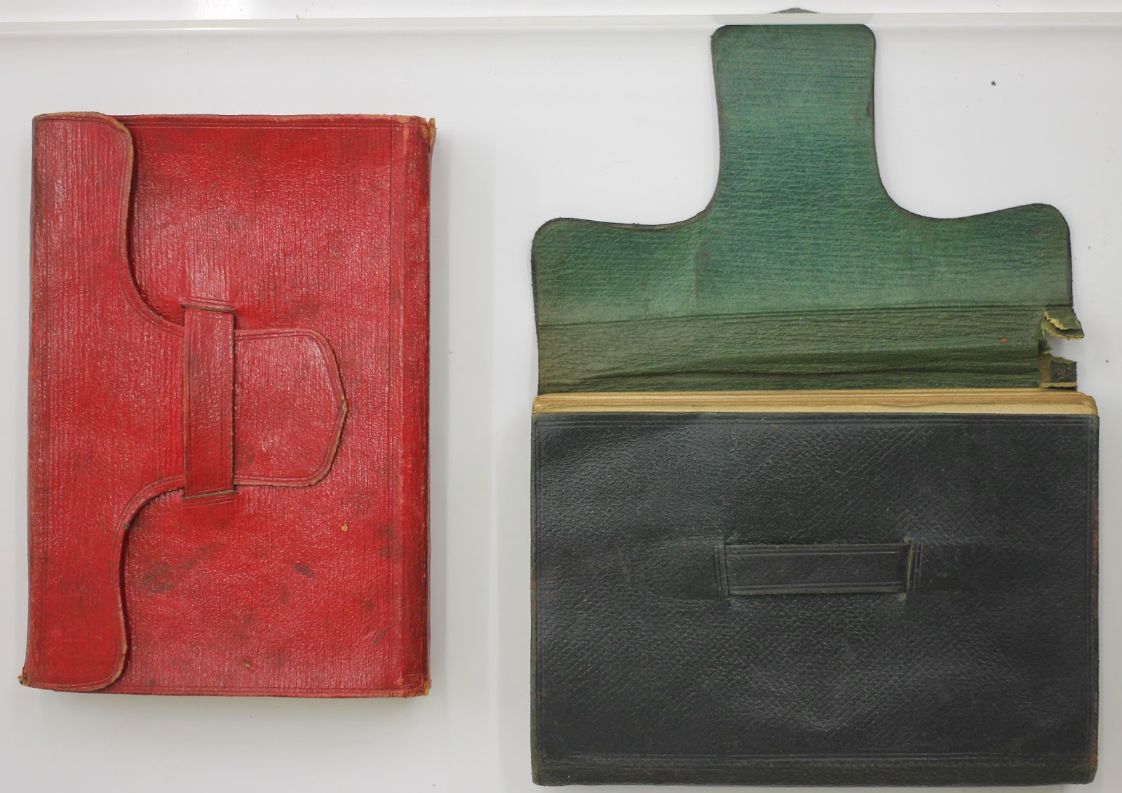 Two leather book-cases, one red and one black