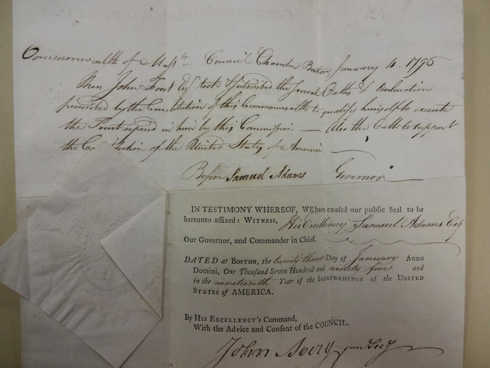 Handwritten document by John Avery alongside a public seal