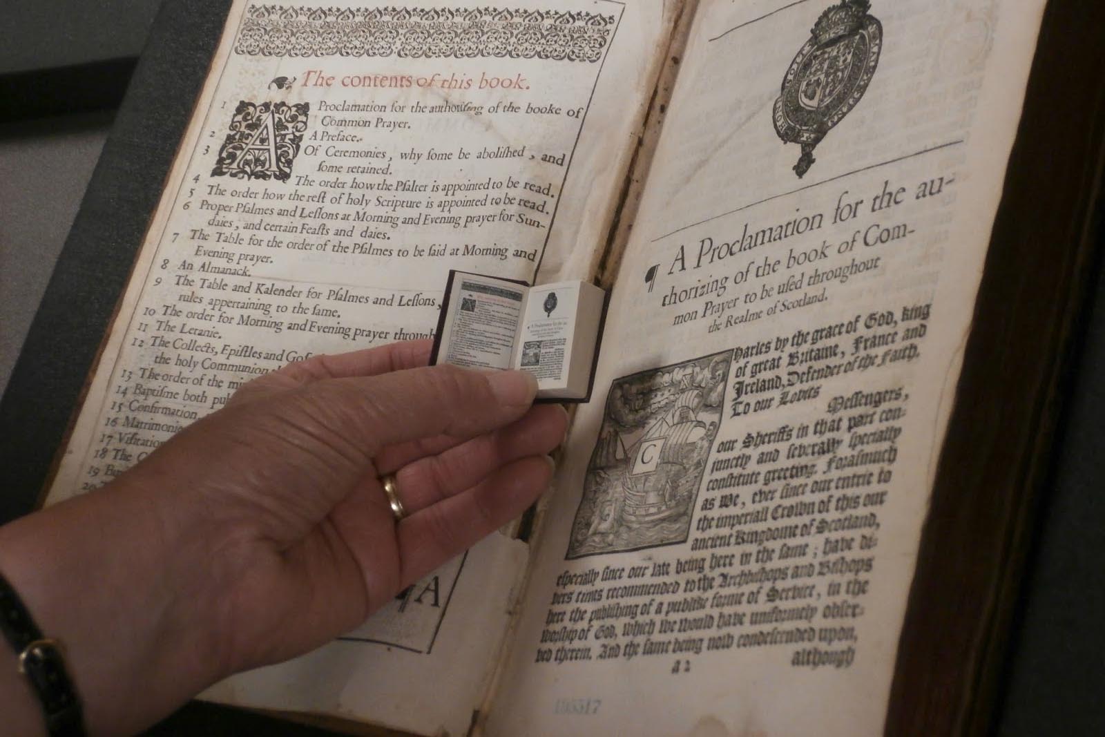 Book of Common Prayer: micro mini size being held next to the traditional size book.