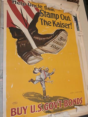 "Help Uncle Sam Stamp Out the Kaiser. Buy US Government Bonds."  with picture of Uncle Sam's foot hovering over a tiny figure of the Kaiser about to crush him.