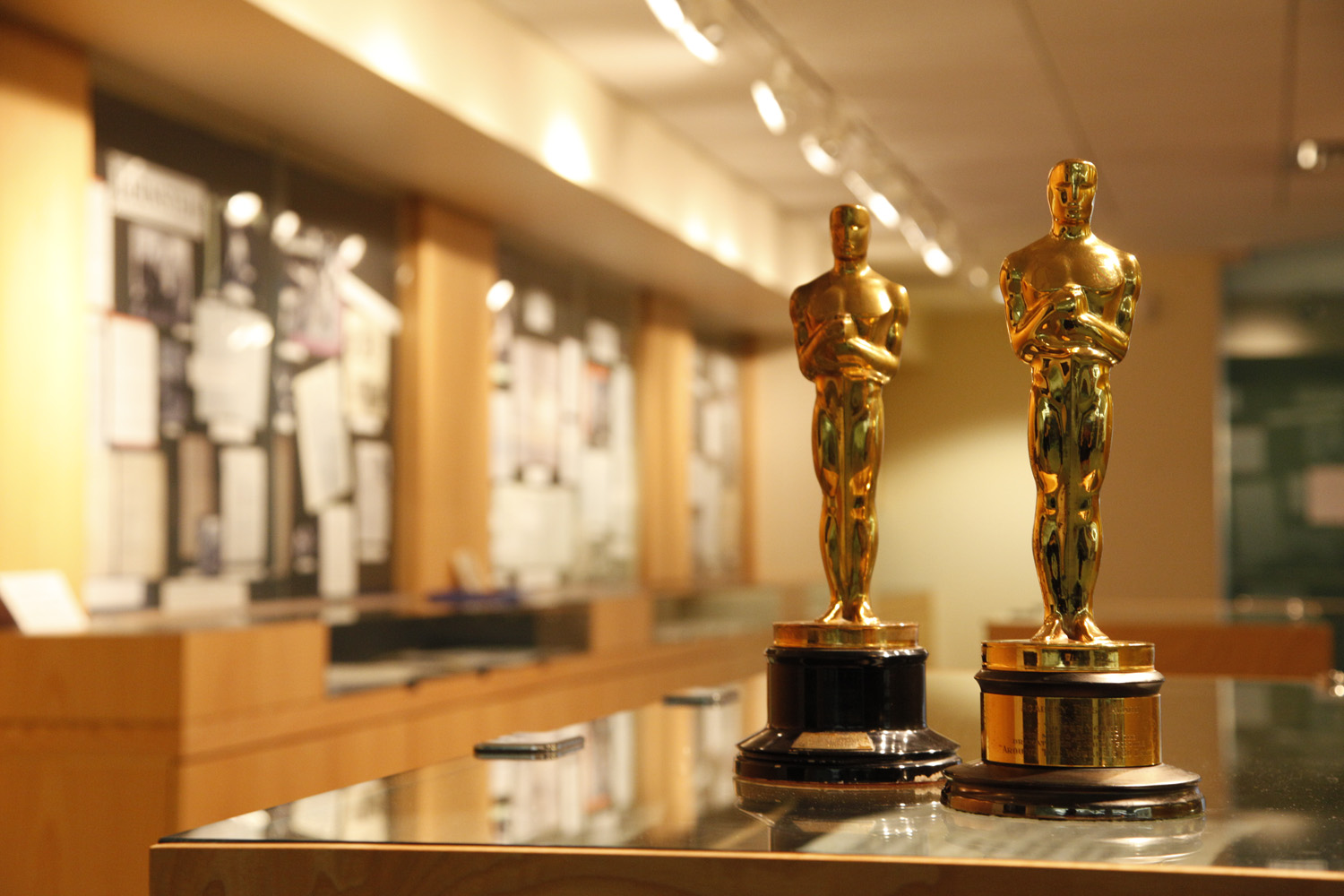 Two Oscars with the Archives and Special Collections Lobby in background