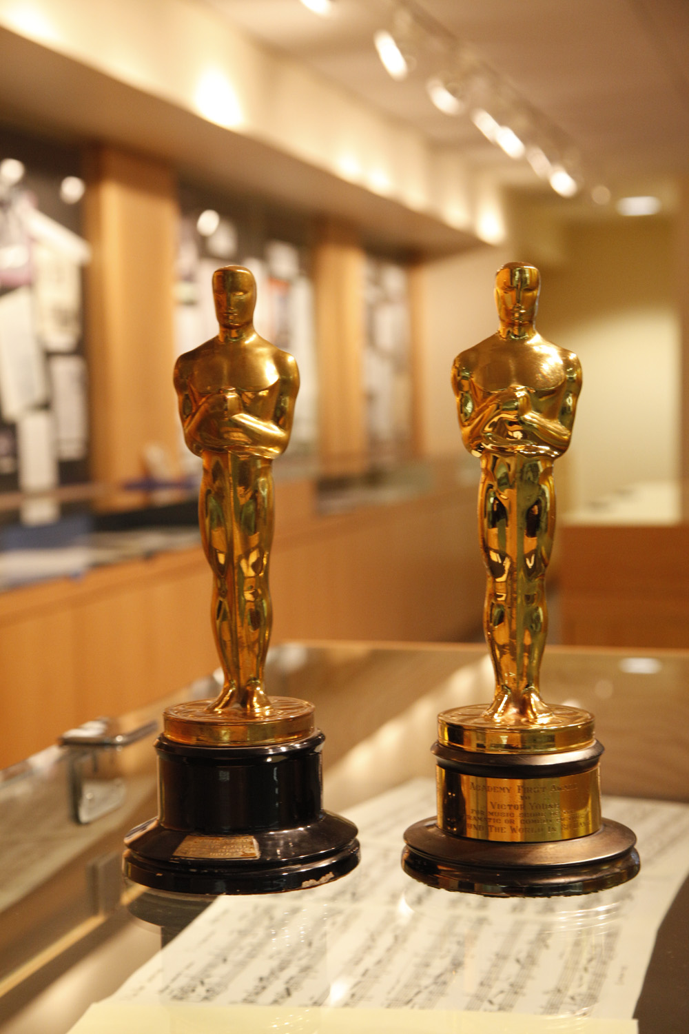 Two Oscars with the Archives and Special Collections Lobby in background