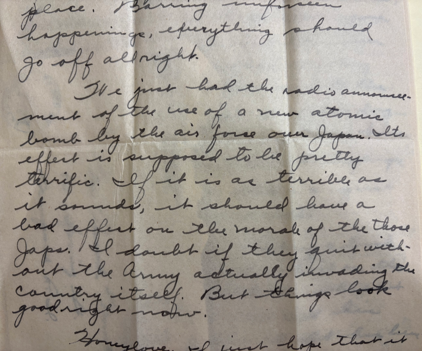Handwritten script reading "I’ve just heard the radio announcement of the use of a new atomic bomb by the air force over Japan. Its effect is supposed to be pretty terrific. If it is as terrible as it sounds, it should have a bad effect on the morale of those Japs. I doubt if they quit without the army actually invading the country itself. But things look good right now."