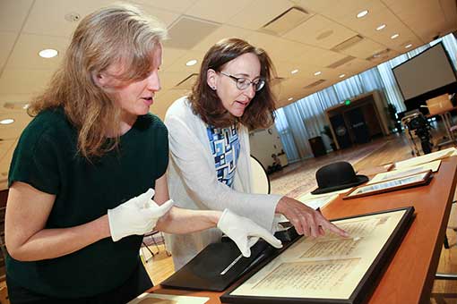 Louisa Brandeis Popkin, great-granddaughter of Justice Louis D. Brandeis, (right) looks over Brandeis family artifacts with Sarah Shoemaker, Associate University Librarian for Archives and Special Collections.