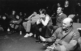 Three Chaplains Forum. Left to Right: Rev. Diane Moore, Rabbi Albert S. Axelrad, Father Maurice Loiselle. Students sit on the floor nearby listening.