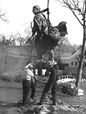 Workmen installing the statue of Justice Brandeis