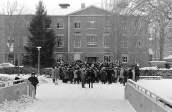 Black Student Occupations of Ford Hall. A large crowd of Black students stands in front of a building. There is snow on the ground.
