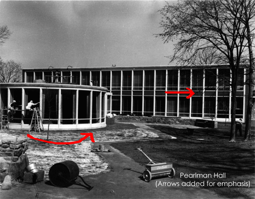 Black and white photo of Pearlman Hall, with red arrows following the curve of the building.  Text at the lower left says: Pearlman Hall (Arrows added for emphasis).