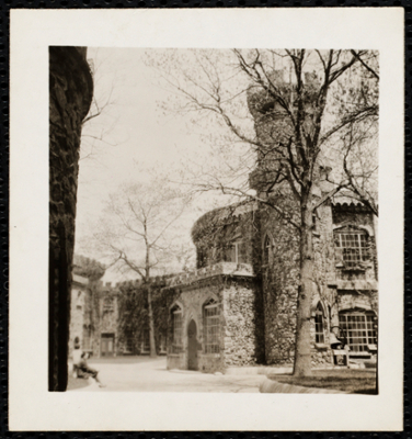 Castle with two people sitting out front.