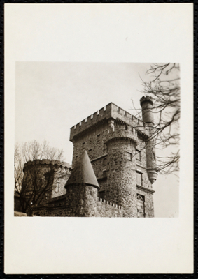 closeup of the tower, stone wall and turrets, looking upwards.