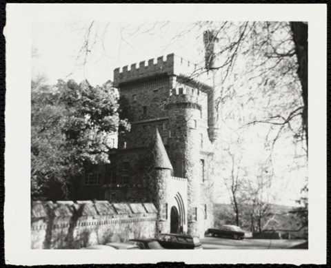 View of the Castle with cars parked out front.