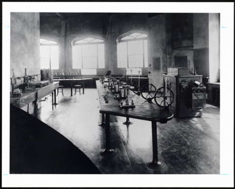 View of lab in the castle with long tables, wood floor and light streaming in from the windows.