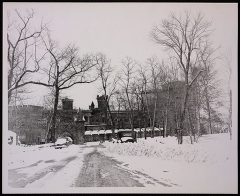 Castle with cars buried in the snow.