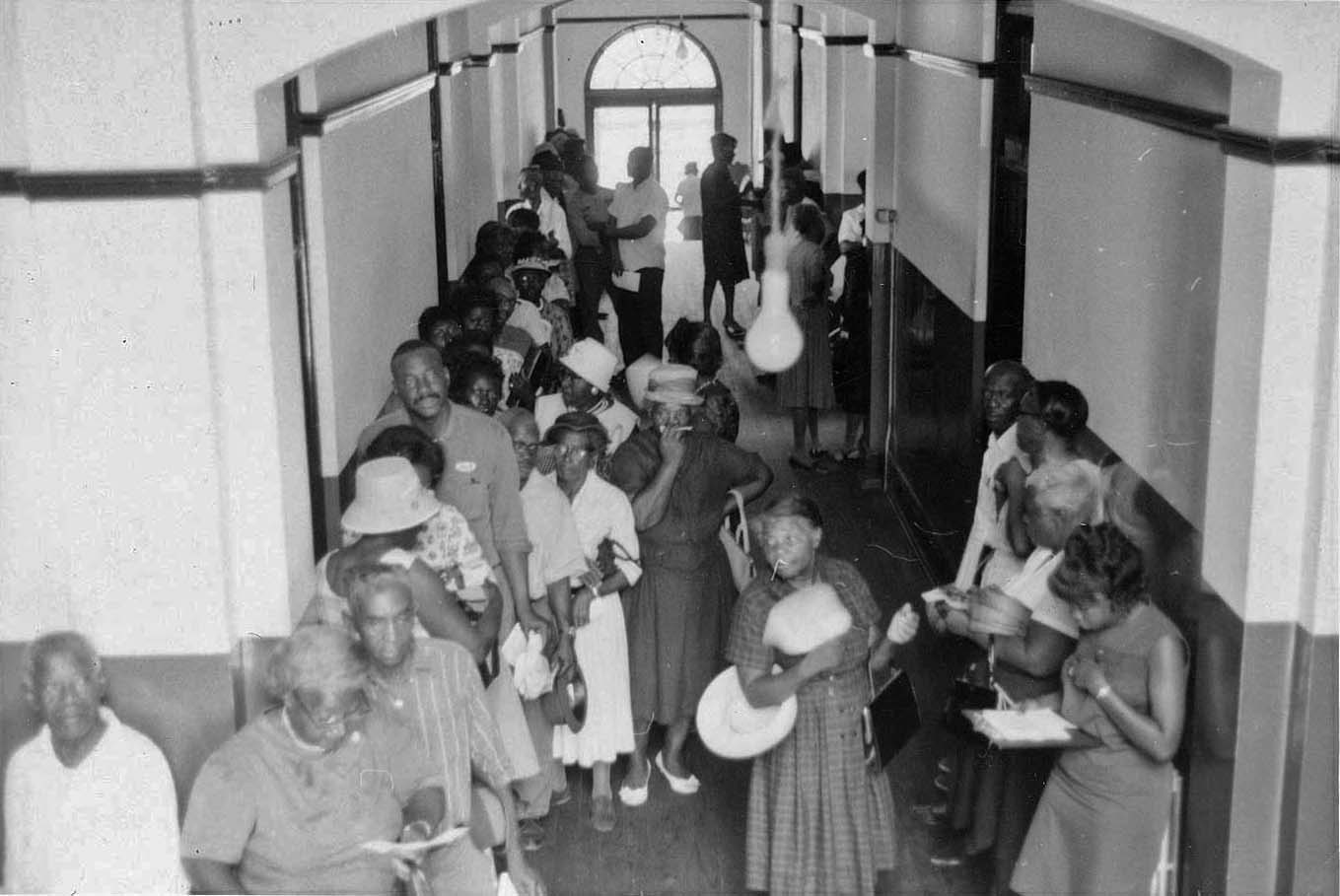 People lined up in the hallway of the courthouse waiting to register to vote