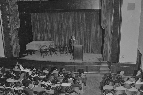 Abram Sachar on the Nathan Seifer Auditorium Stage addressing an audience