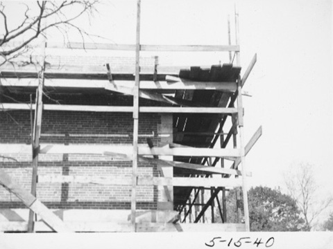 Looking upward at the corner of the building with scaffolding