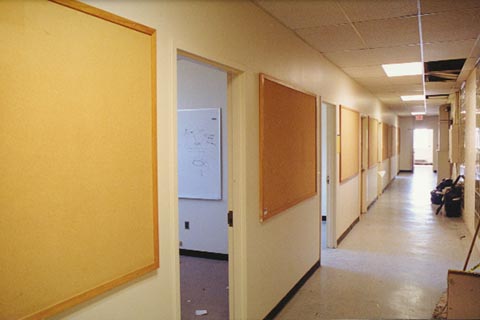 A hallway with empty bulletin boards in Ford Hall. July 2000