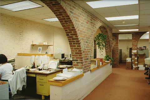 Central Development Records, located on the first floor. This interior space has brick arches separating the work spaces from the hallways .July 2000