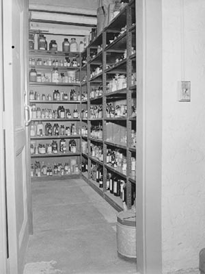 Science Stockroom: a small room lined with shelves containing bottles and jars.