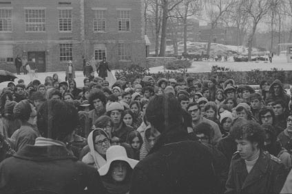 Students gather outside Berstein-Marcus and Gryzmish in support of the occupying Ford Hall students. Ford Hall is in the background of this photograph. 