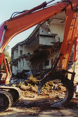 Side of the building without the facade is framed by the arc of the excavator's enormous "claw" in this picture.