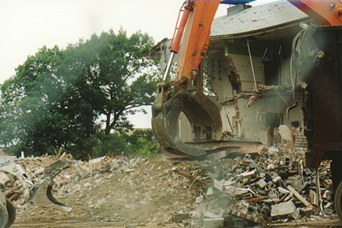 The exacavator's "claw" is shown here picking up debris using an I-beam.