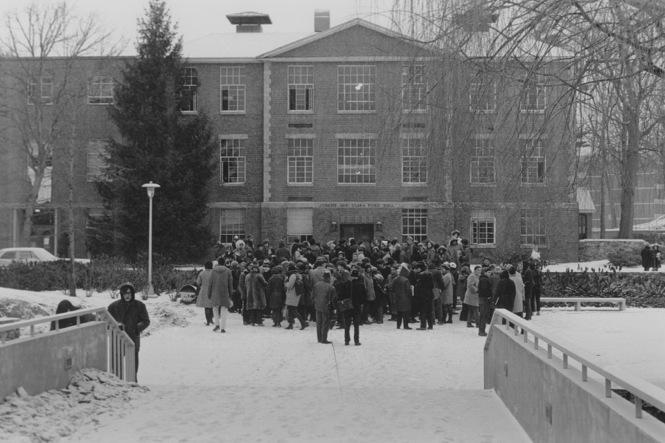 A crowd gathers in front of Ford Hall to protest