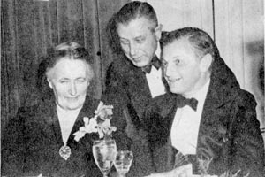 Susan Brandeis, George Alpert and Ralph Lazrus at a Fundraising Event at the Hotel Somerset in 1947. Brandeis and Alpert are seated. Lazrus is standing in between them.